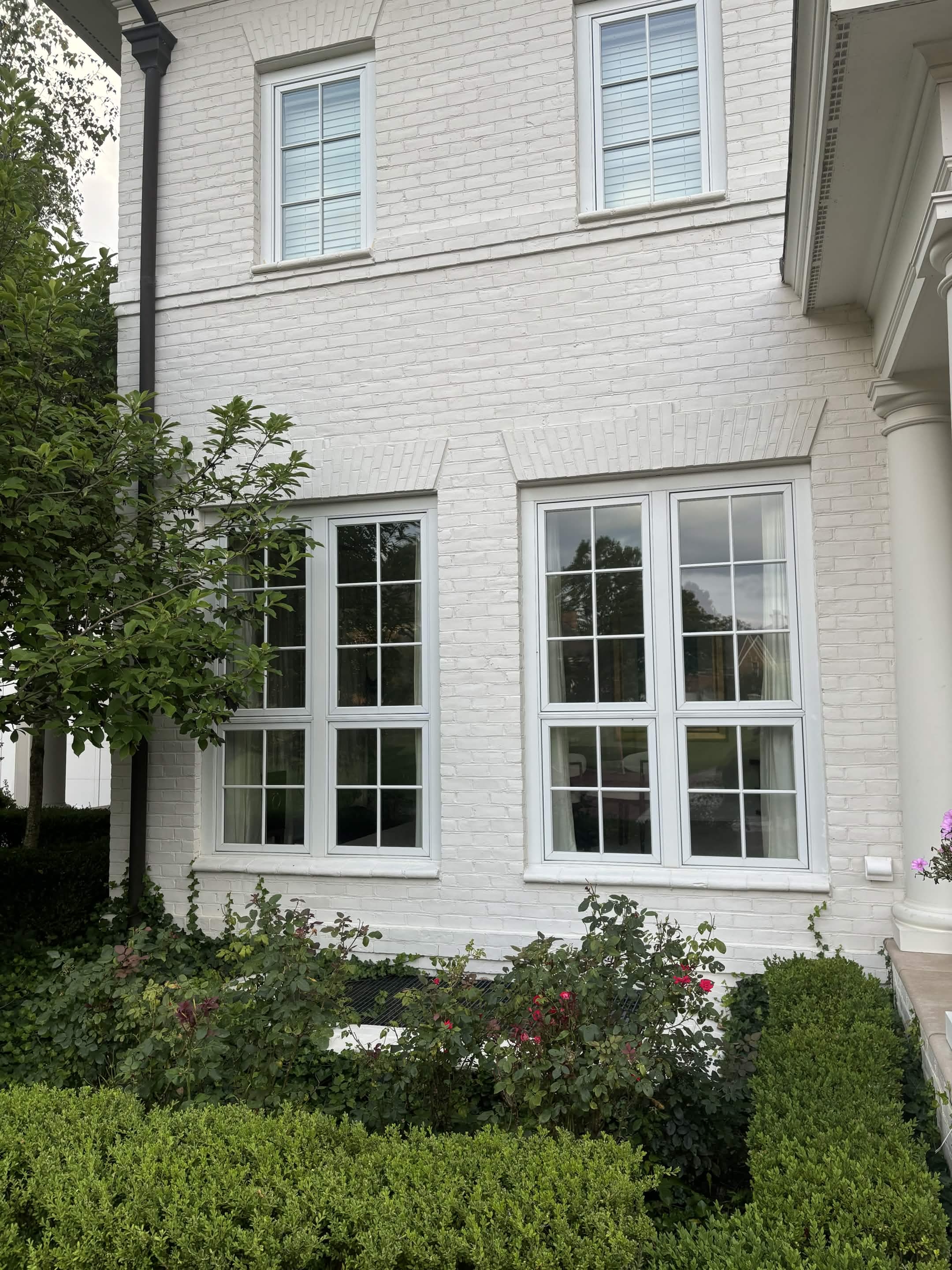 Freshly cleaned windows on a white brick home with manicured landscaping in Central Ohio